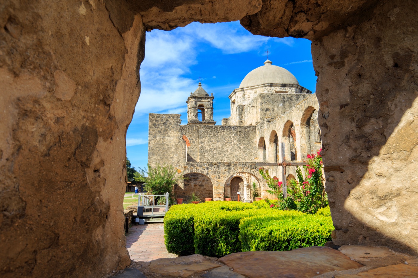 Mission San Jose stone archway domed church garden hedges, San Antonio