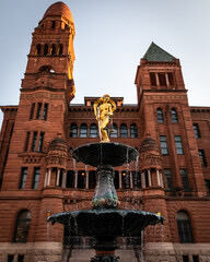 Bexar courthouse red sandstone tower golden statue fountain, San Antonio